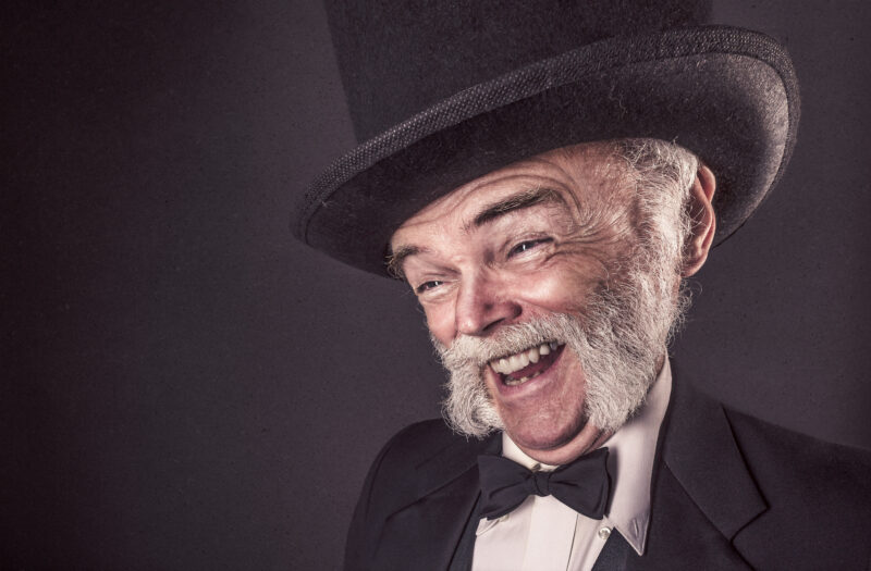 Smiling Man in Goofy Hat Free Stock Photo